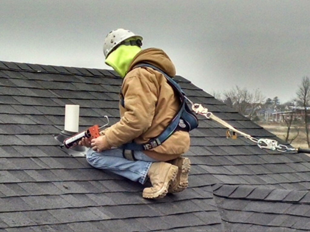 Zander employee installing radon vent in roof