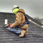 Zander employee installing radon vent in roof