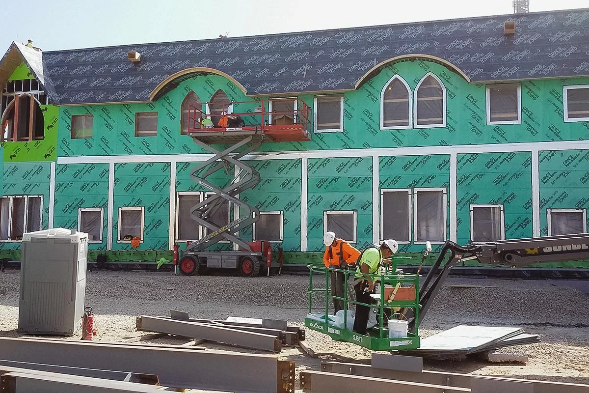 Air barrier being applied to a large building