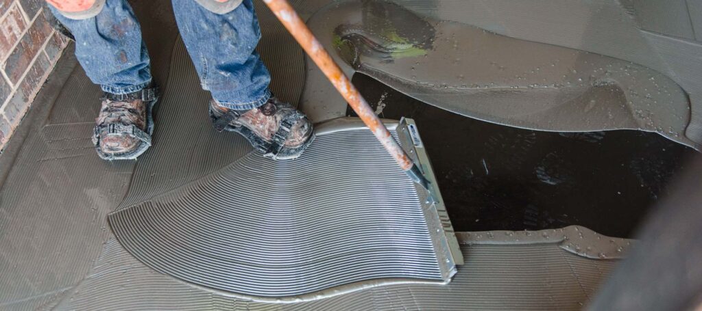 Zander employees installing epoxy flooring