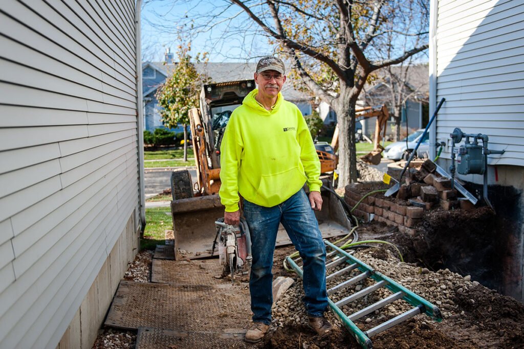 Zander employee smiling at a job site