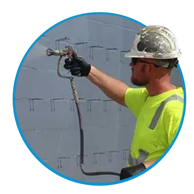 Zander employee spraying on coating