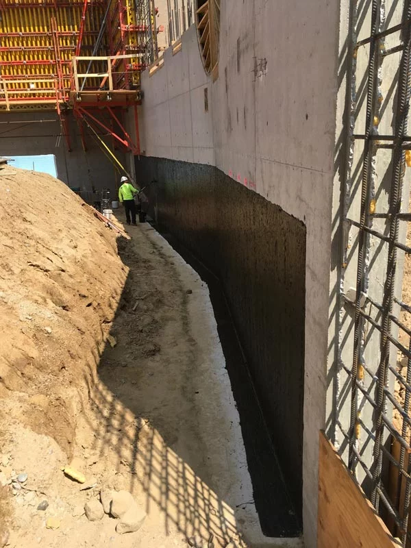 hot applied waterproofing on the side of a building