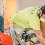 Zander employees installing drain tiles