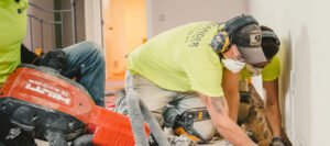 Zander employees installing drain tiles