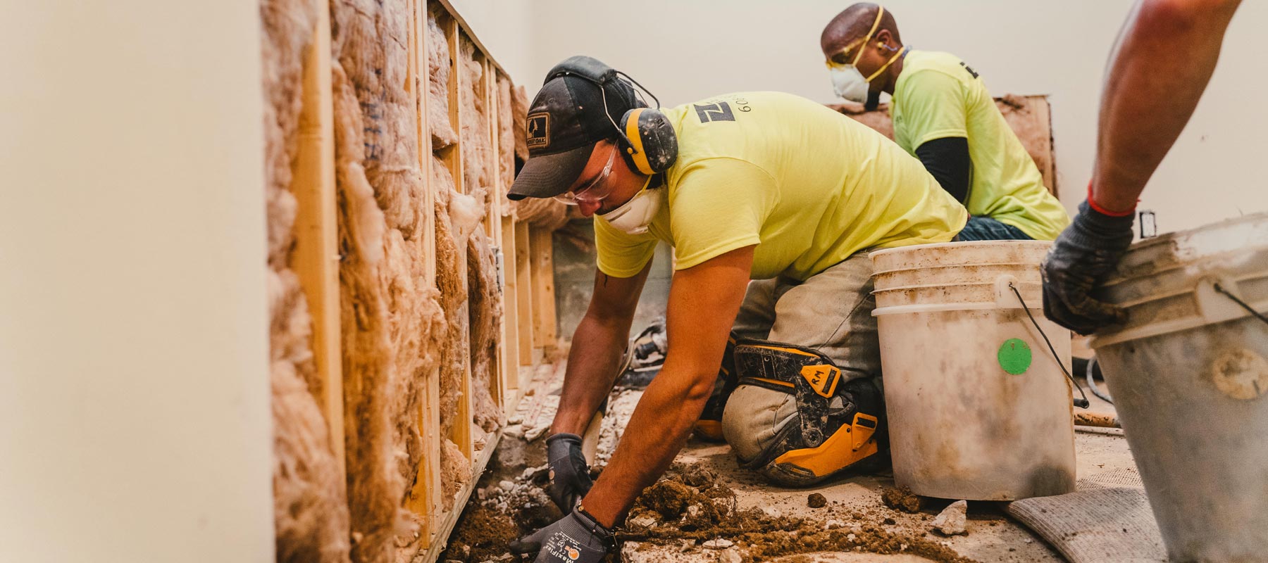 Zander employees installing drain tile