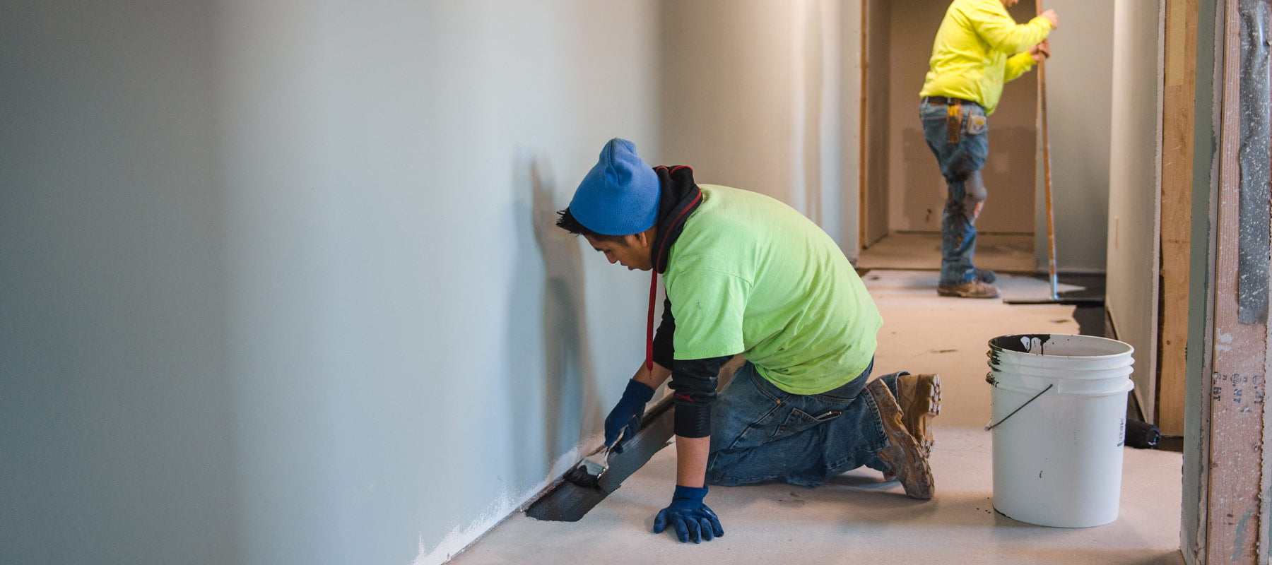 Zander employee applying epoxy flooring