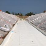waterproof membranes being applied at a site