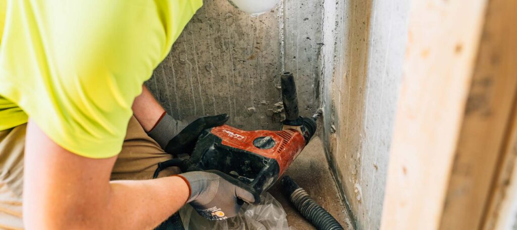 Zander employee drilling into a wall