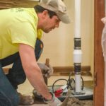 Zander employee installing sump pump