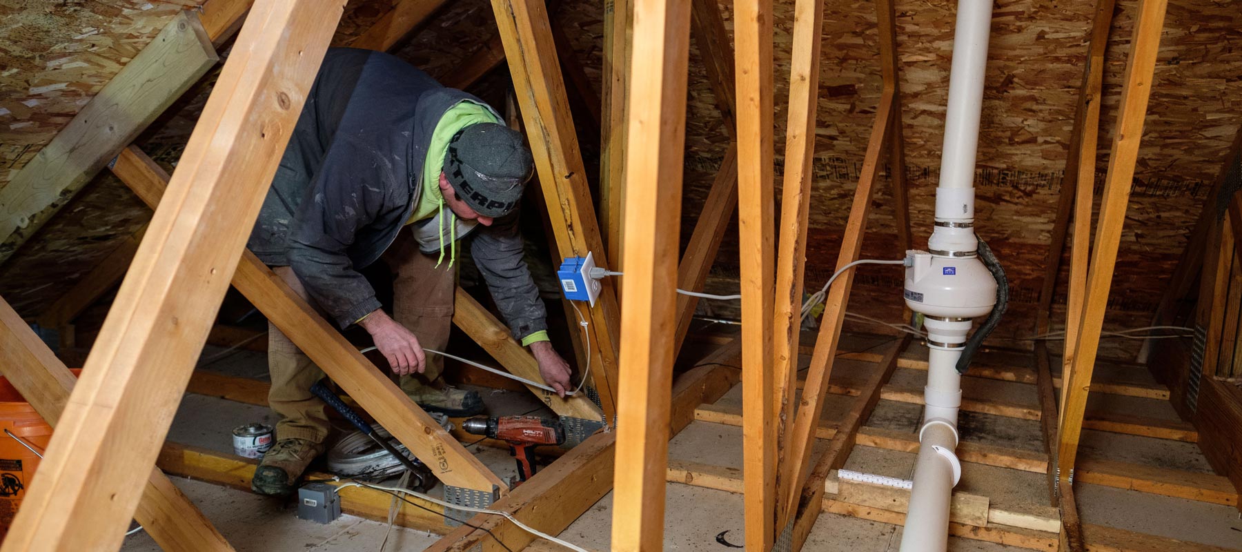 Zander employee setting up radon mediation system