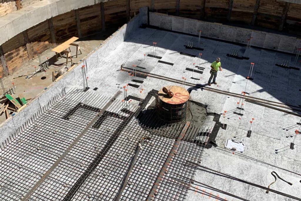 a large job site with a Zander employee working
