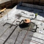 a large job site with a Zander employee working