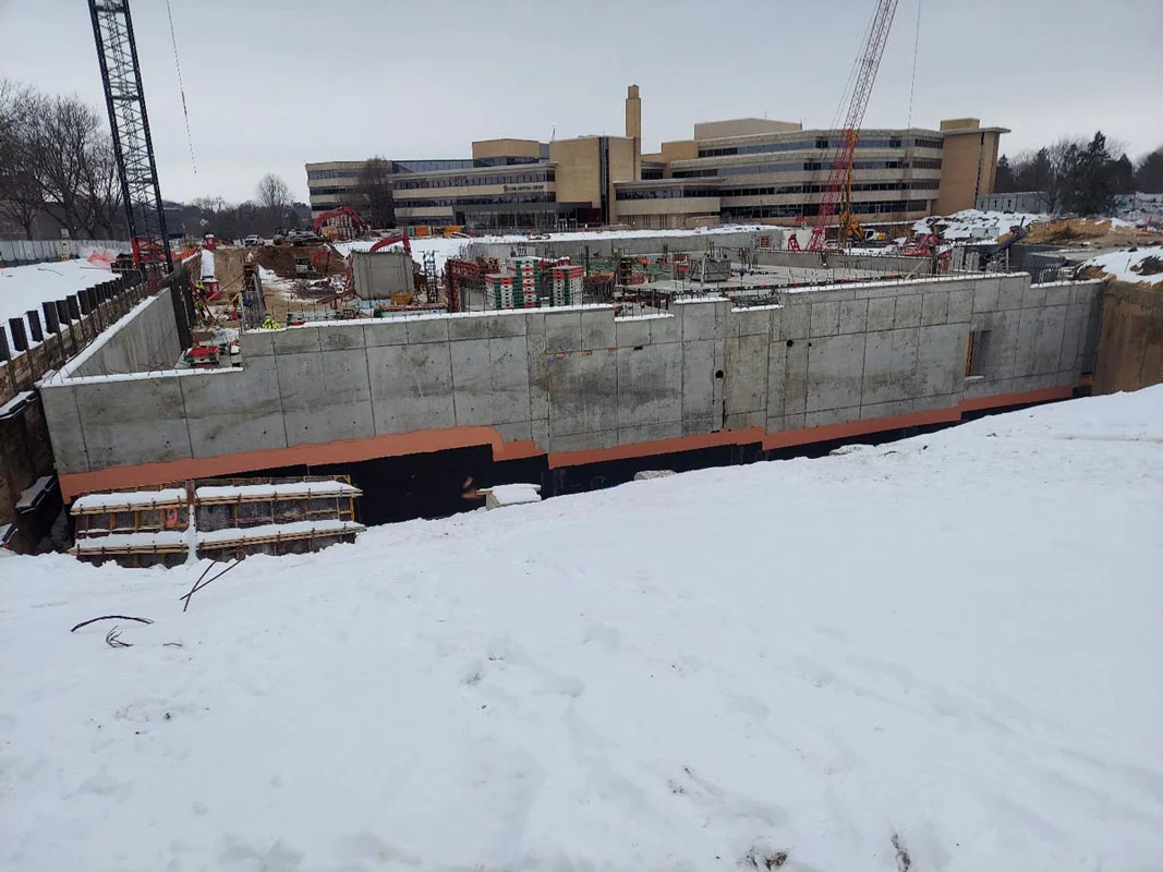 a large structure being built with waterproofing applied all around it