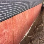a trench along a wall with panels on the wall