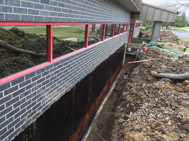 a trench along the wall of a building