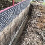 a trench dug out around a wall