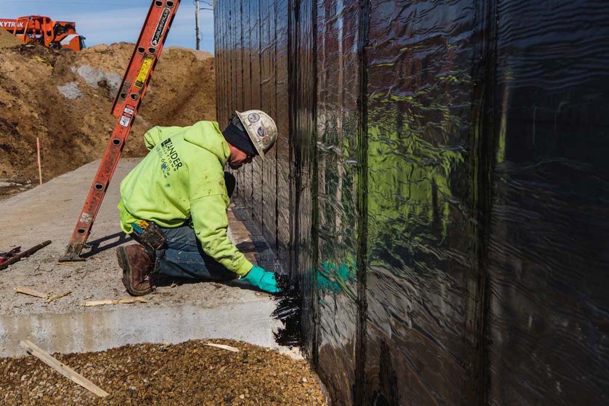 Zander employee working on a wall