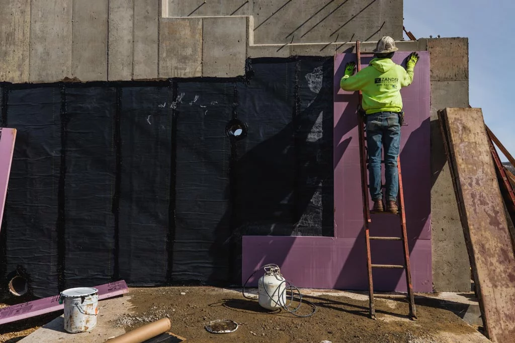 Zander employee applying a panel to a wall