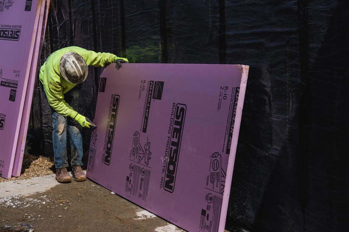 Zander employee picking up a panel