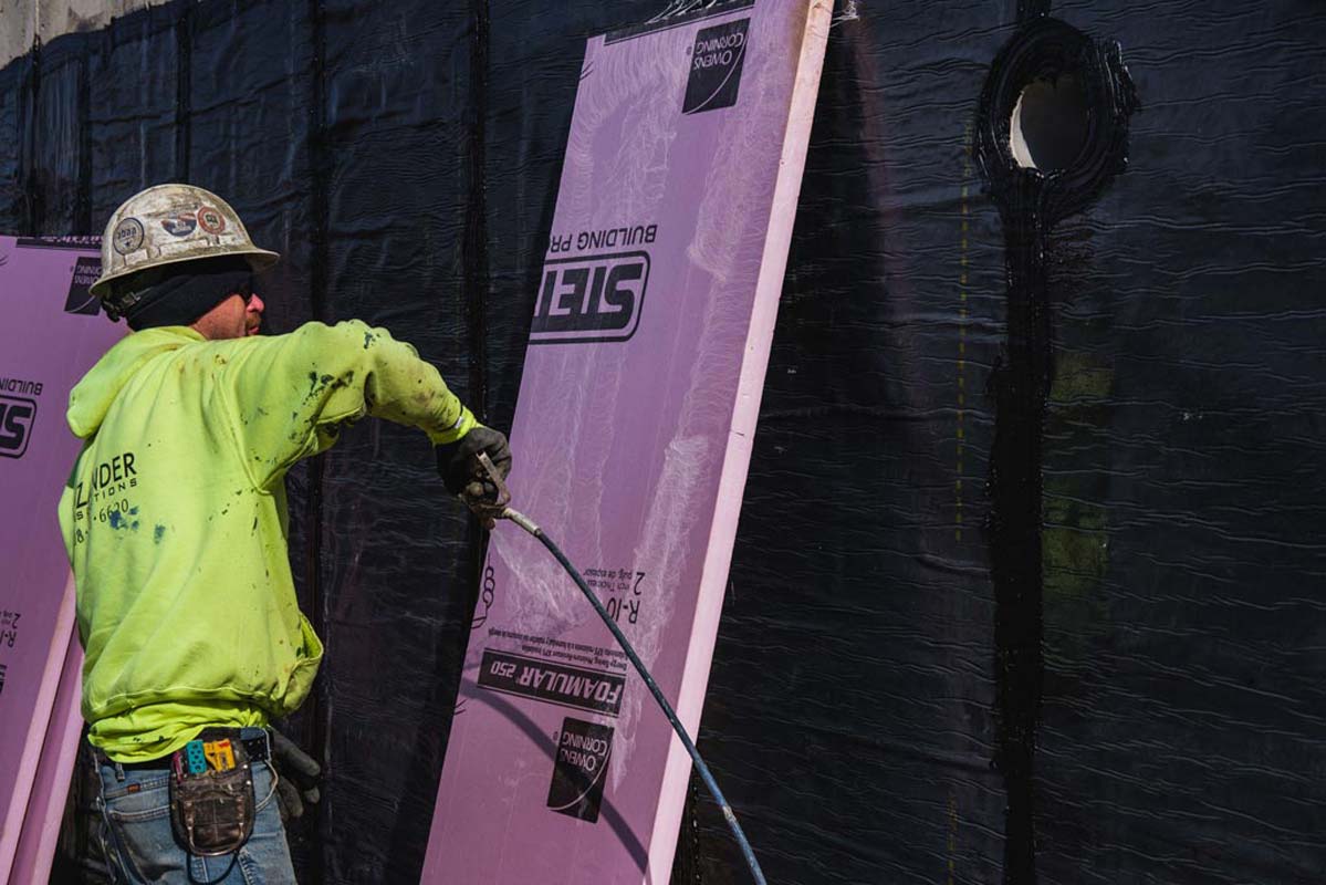 Zander employee applying adhesive to a panel