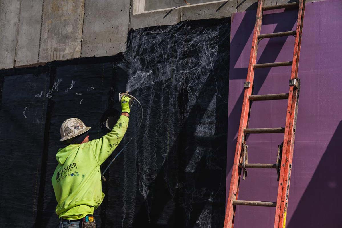 Zander employee applying adhesive