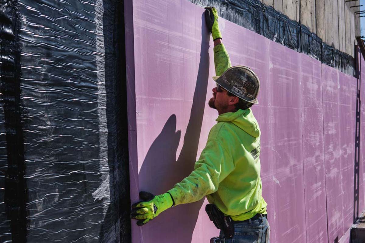 Zander employee applying a panel to a wall