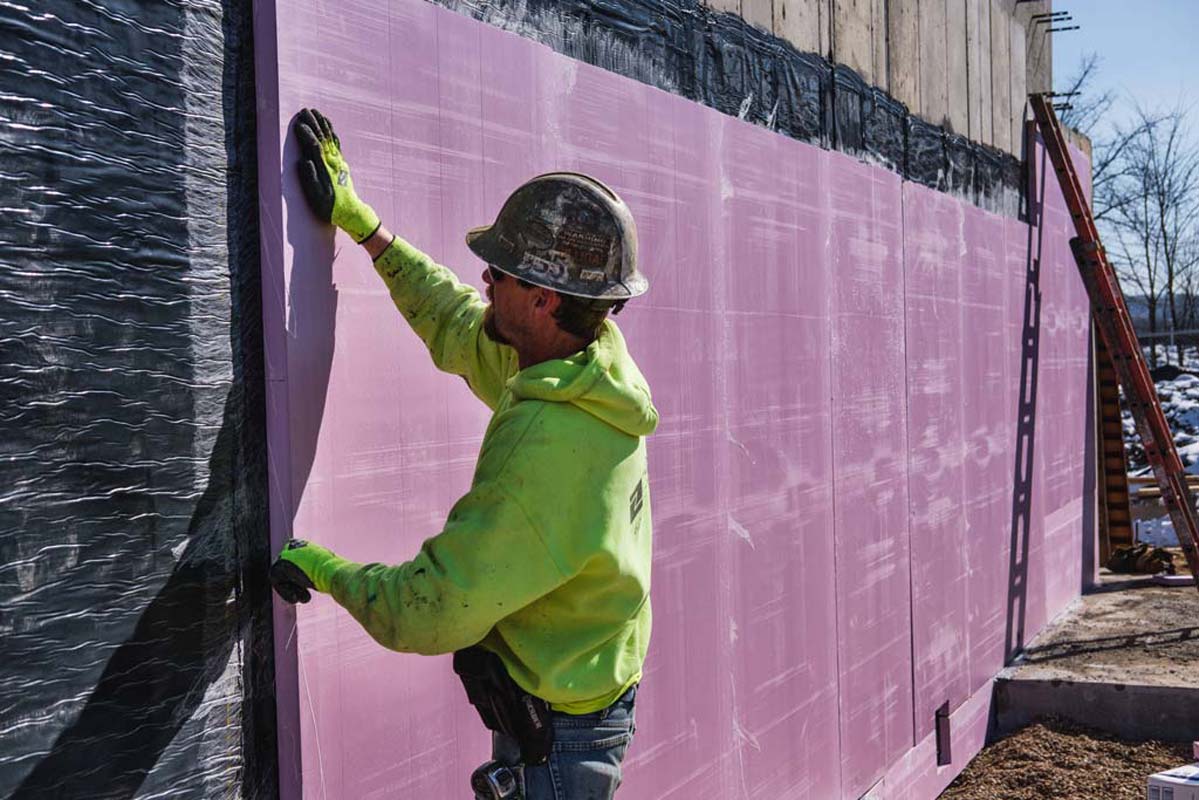 Zander employee applying a panel to a wall