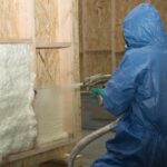 worker blowing insulation