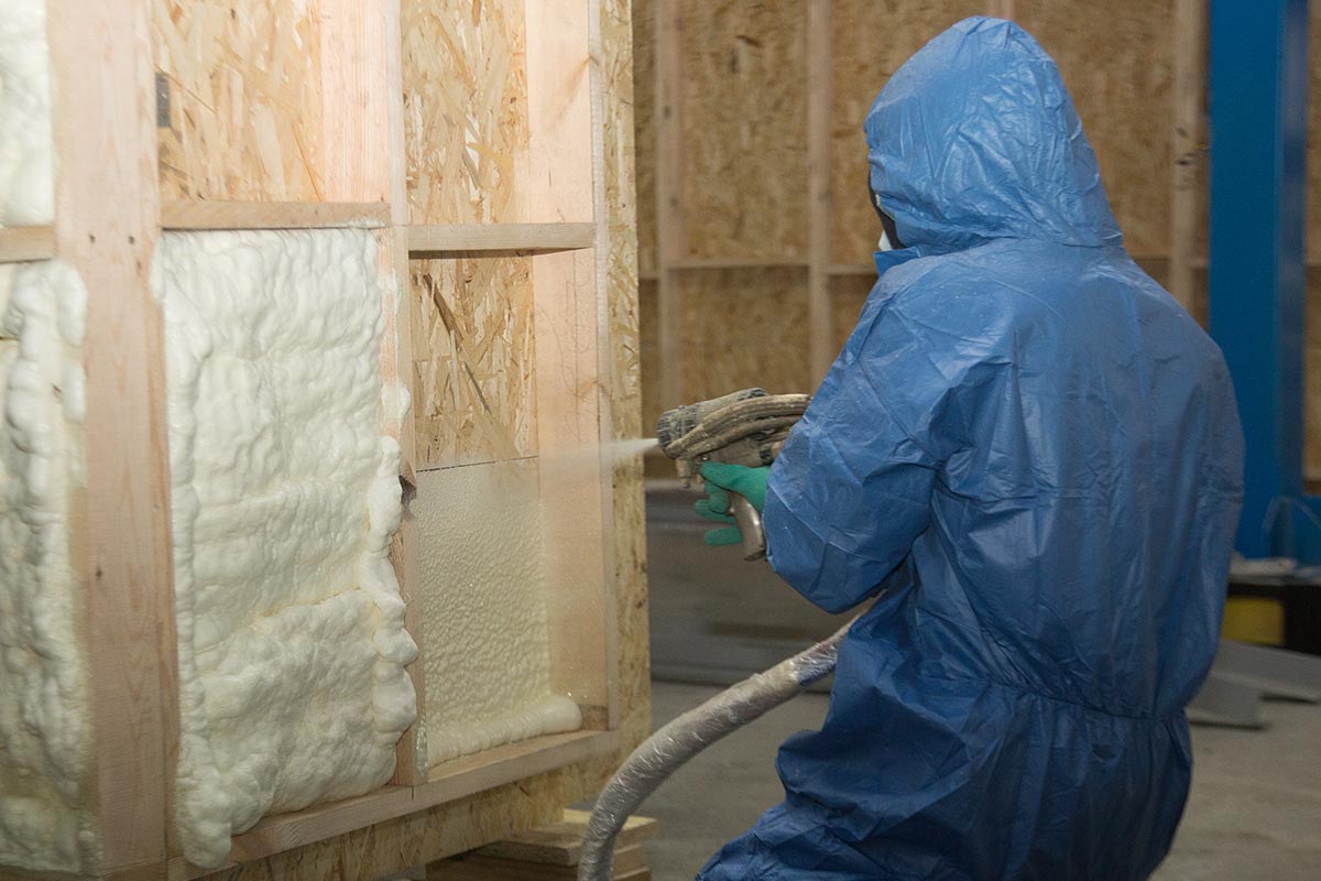 worker blowing insulation