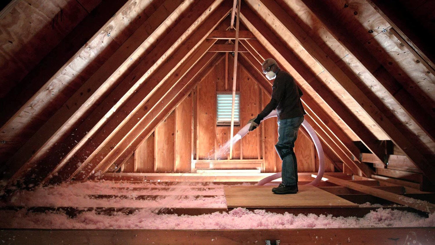 worker blowing in insulation