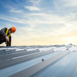 A commercial roofer inspects a commercial roof.